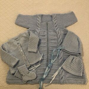 Hand crochet knitted baby clothes bundle.